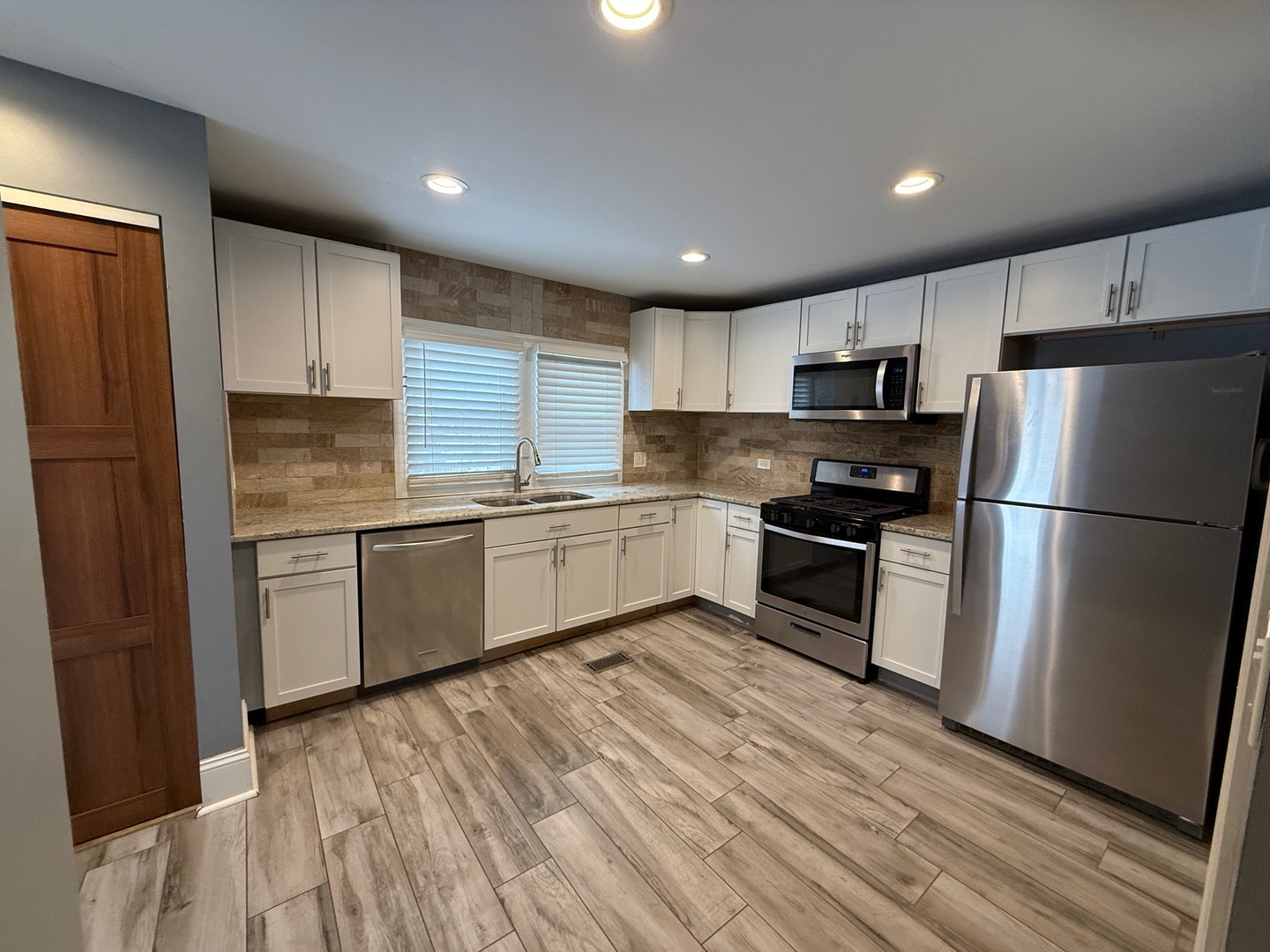 15036 West Russell Road Zion, IL 60099 - Photo 4 of 13 a kitchen with a refrigerator a sink and a stove top oven