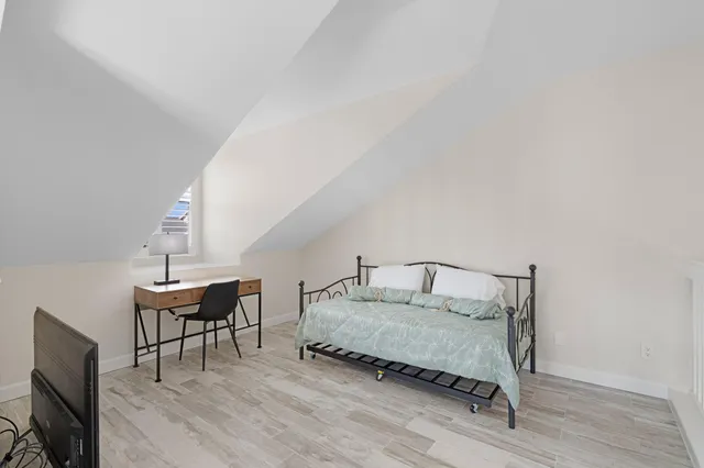 a bedroom with a bed and a table