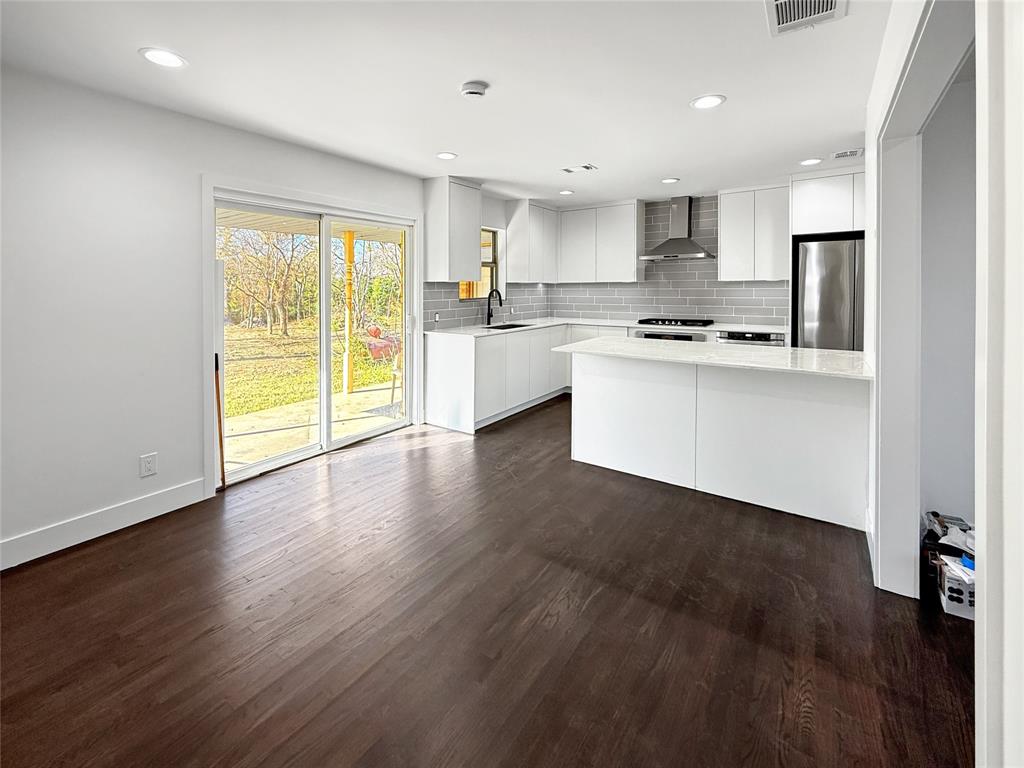 425 Chesier Road Lancaster, TX 75146 - Photo 6 of 15 a kitchen with stainless steel appliances granite countertop a stove a sink and a refrigerator