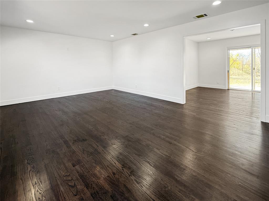 425 Chesier Road Lancaster, TX 75146 - Photo 8 of 15 an empty room with wooden floor and windows