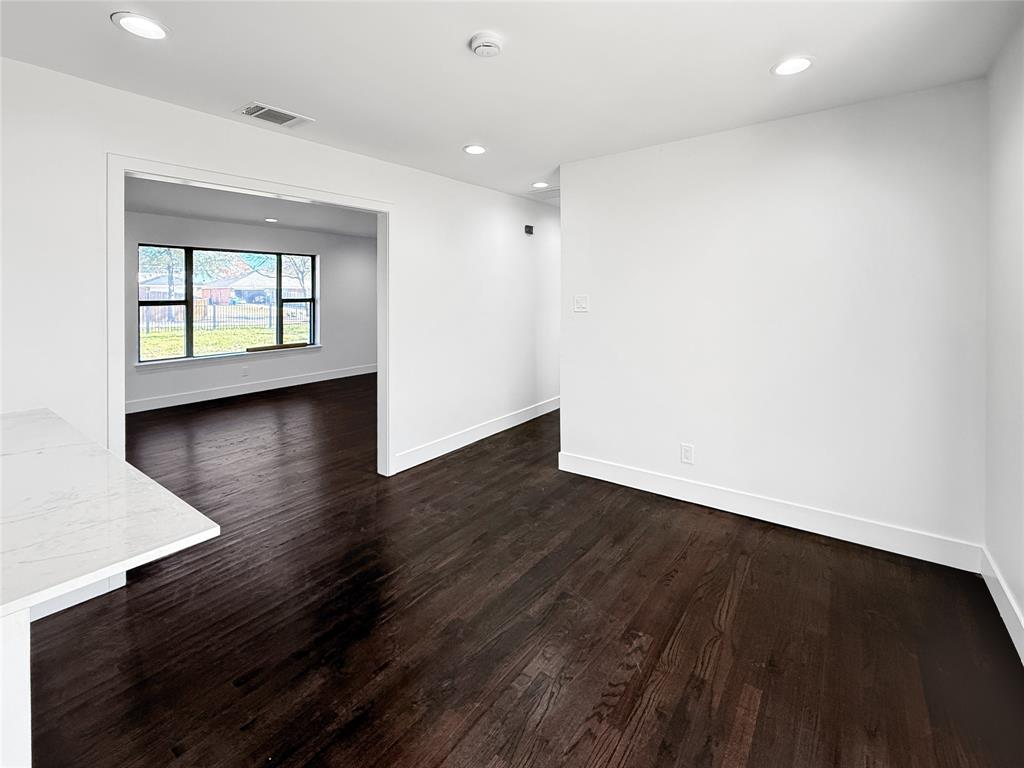 425 Chesier Road Lancaster, TX 75146 - Photo 10 of 15 an empty room with wooden floor and windows