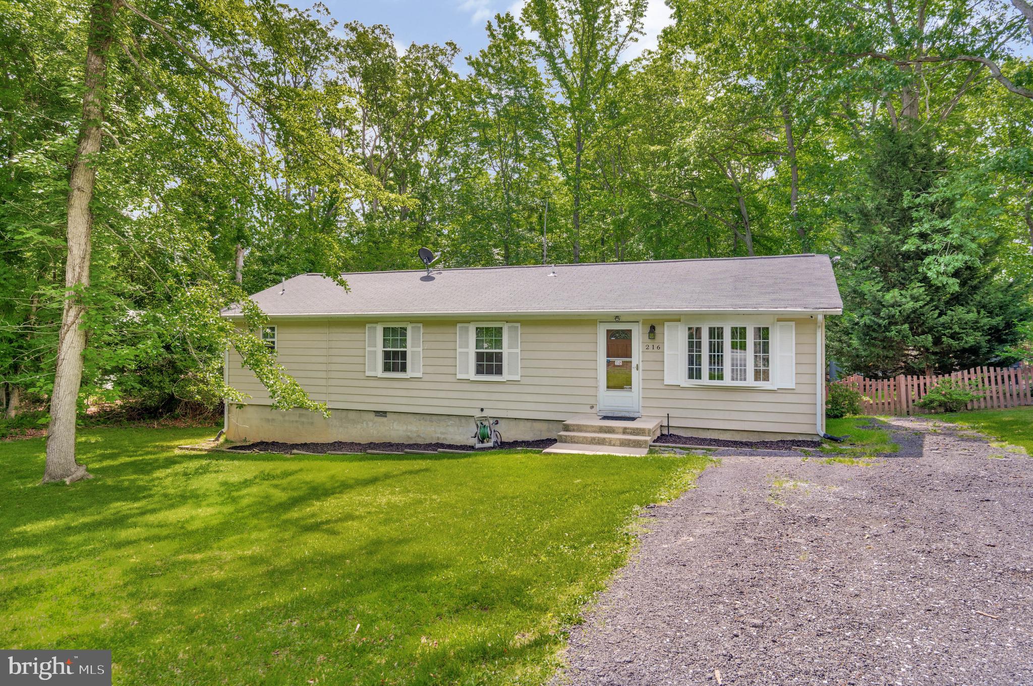 216 Manning Road East Accokeek, MD 20607 - Photo 3 of 32 a front view of house with yard and green space