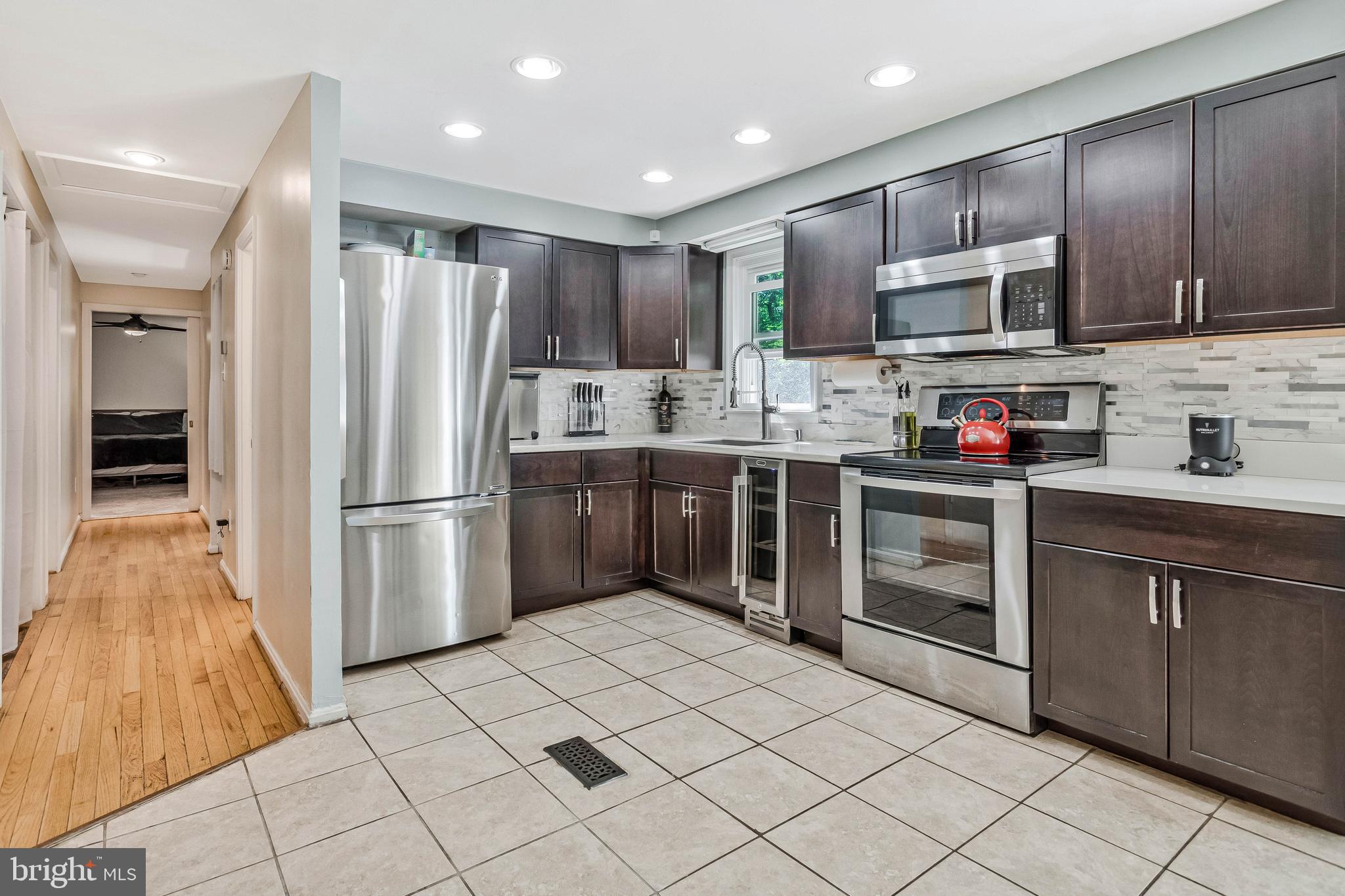 216 Manning Road East Accokeek, MD 20607 - Photo 9 of 32 a kitchen with stainless steel appliances granite countertop a refrigerator sink and cabinets