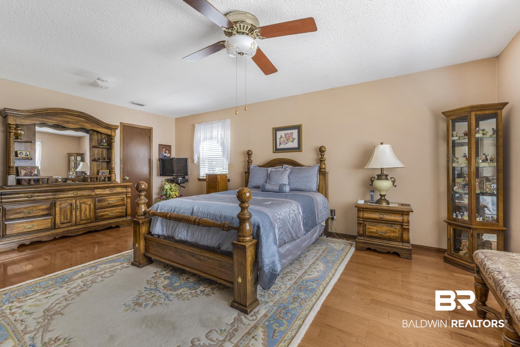 10207 Plantation Drive Daphne, AL 36526 - Photo 20 of 48 Bedroom featuring wood finished floors, ceiling fan, and a textured ceiling