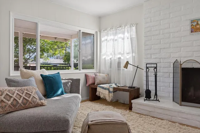 a bedroom with furniture and a large window