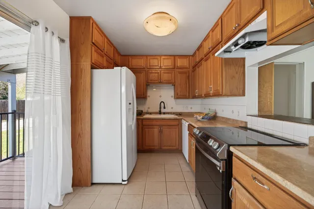 a kitchen with a sink appliances and cabinets