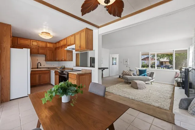 a living room with stainless steel appliances kitchen island granite countertop furniture and a view of kitchen