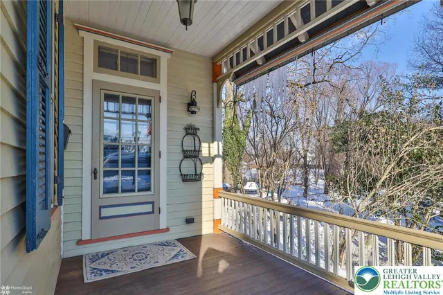 a view of a dining room with furniture a chandelier and wooden floor