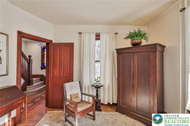a kitchen that has a table chairs and refrigerator