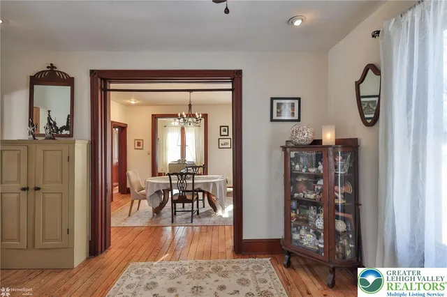 a living room with a fireplace windows and wooden floor