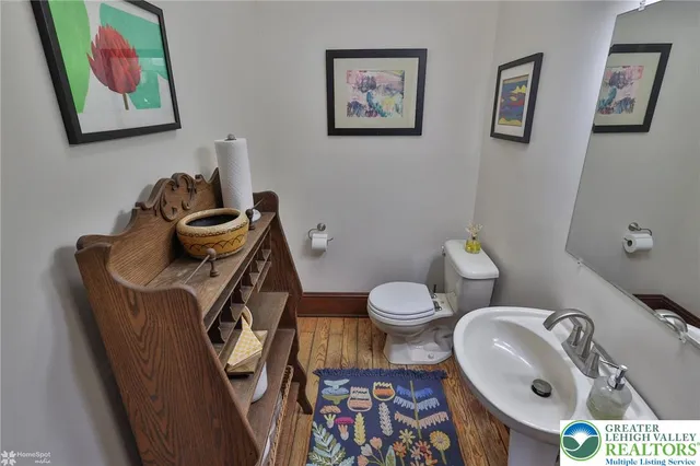 a living room with furniture a refrigerator and a flat screen tv