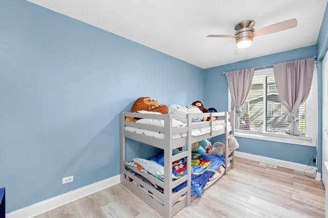 a bedroom with furniture and a baby crib
