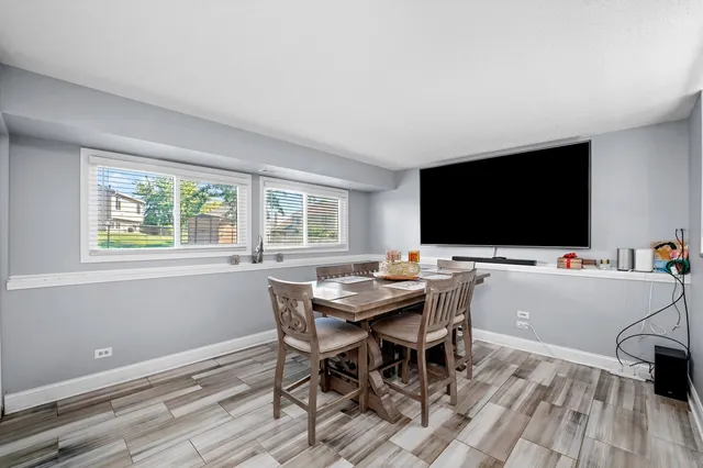 a view of a dining room with furniture and wooden floor