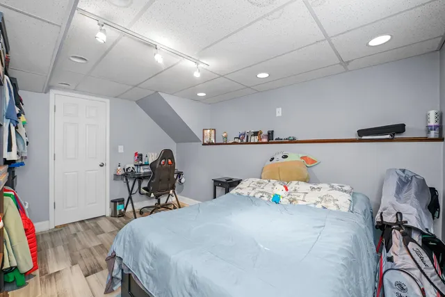 a bed room with a bed and a chair