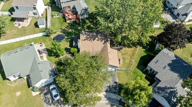 an aerial view of a house with a yard and garden