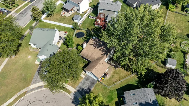 an aerial view of a house with a yard and garden