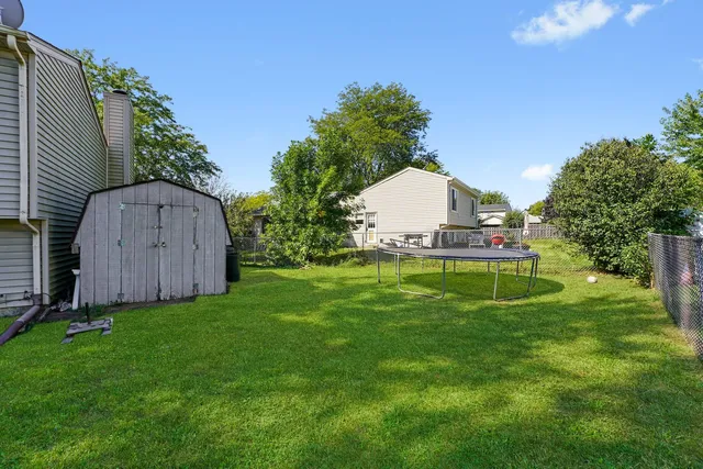 a view of a backyard with a house and a garden