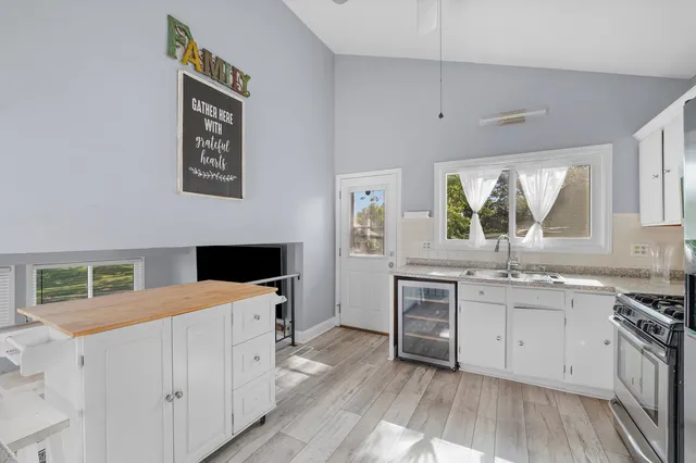 a kitchen with a stove a sink and a microwave