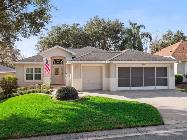 a front view of a house with a garden and yard