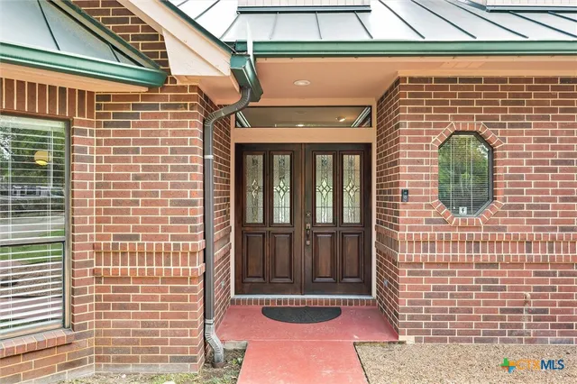 a view of front door of house with outdoor space