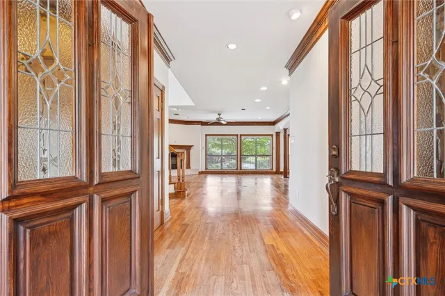 a view of hallway with wooden floor and staircase