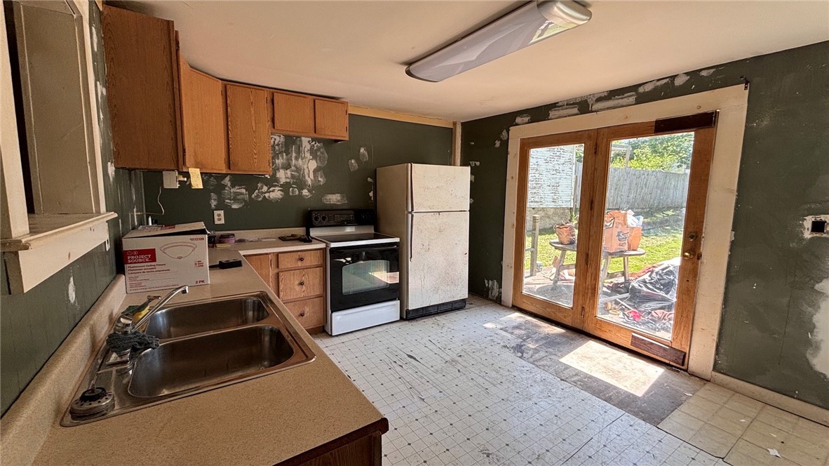 73 West Main Street Le Roy, NY 14482 - Photo 15 of 32 Kitchen. Glass door leads to deck