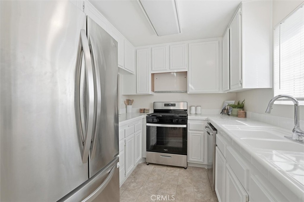 3101 Plaza Del Amo, Unit 8 Torrance, CA 90503 - Photo 11 of 31 a kitchen with stainless steel appliances granite countertop a refrigerator sink and stove