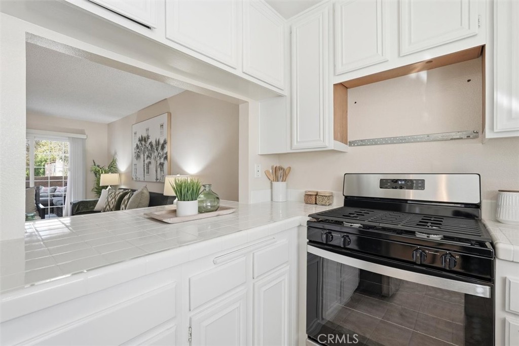 3101 Plaza Del Amo, Unit 8 Torrance, CA 90503 - Photo 12 of 31 a kitchen with stainless steel appliances a sink stove and cabinets