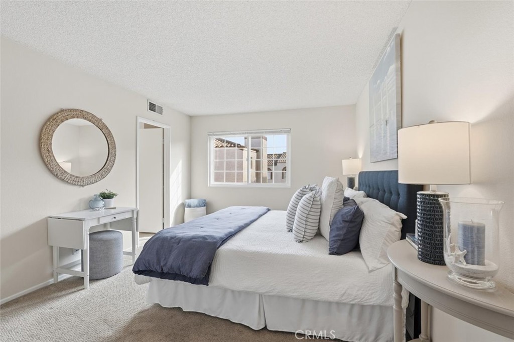 3101 Plaza Del Amo, Unit 8 Torrance, CA 90503 - Photo 15 of 31 a bedroom with a large bed and a lamp