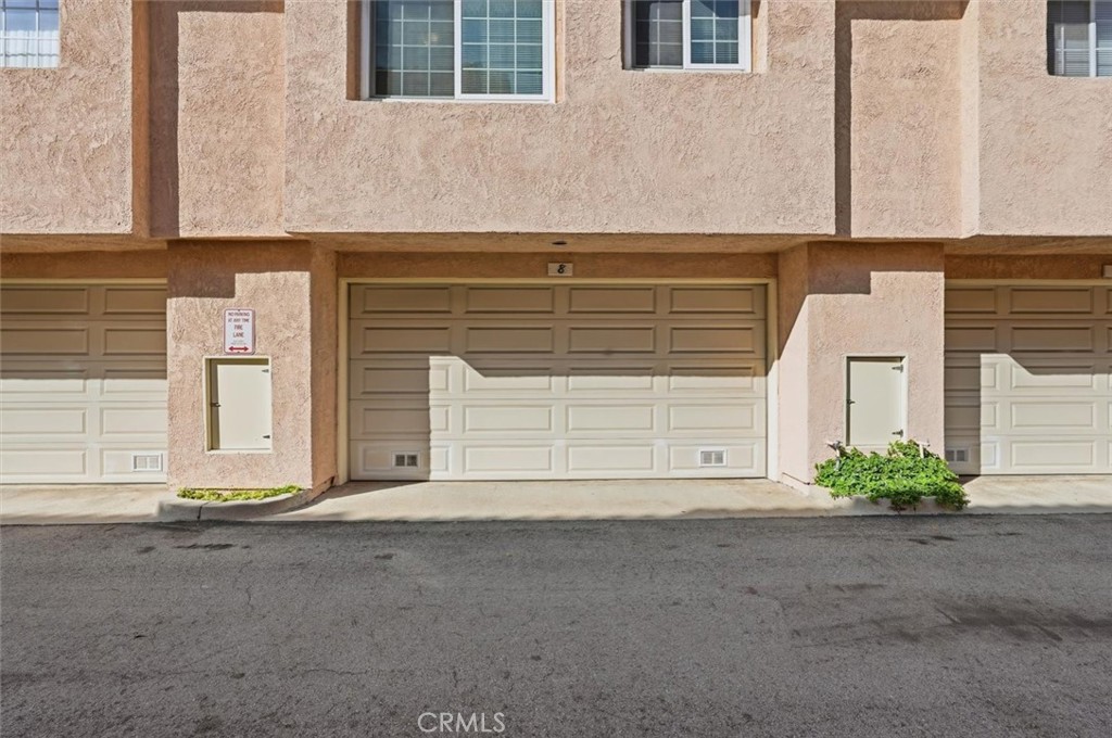 3101 Plaza Del Amo, Unit 8 Torrance, CA 90503 - Photo 28 of 31 a front view of a house with a yard and garage