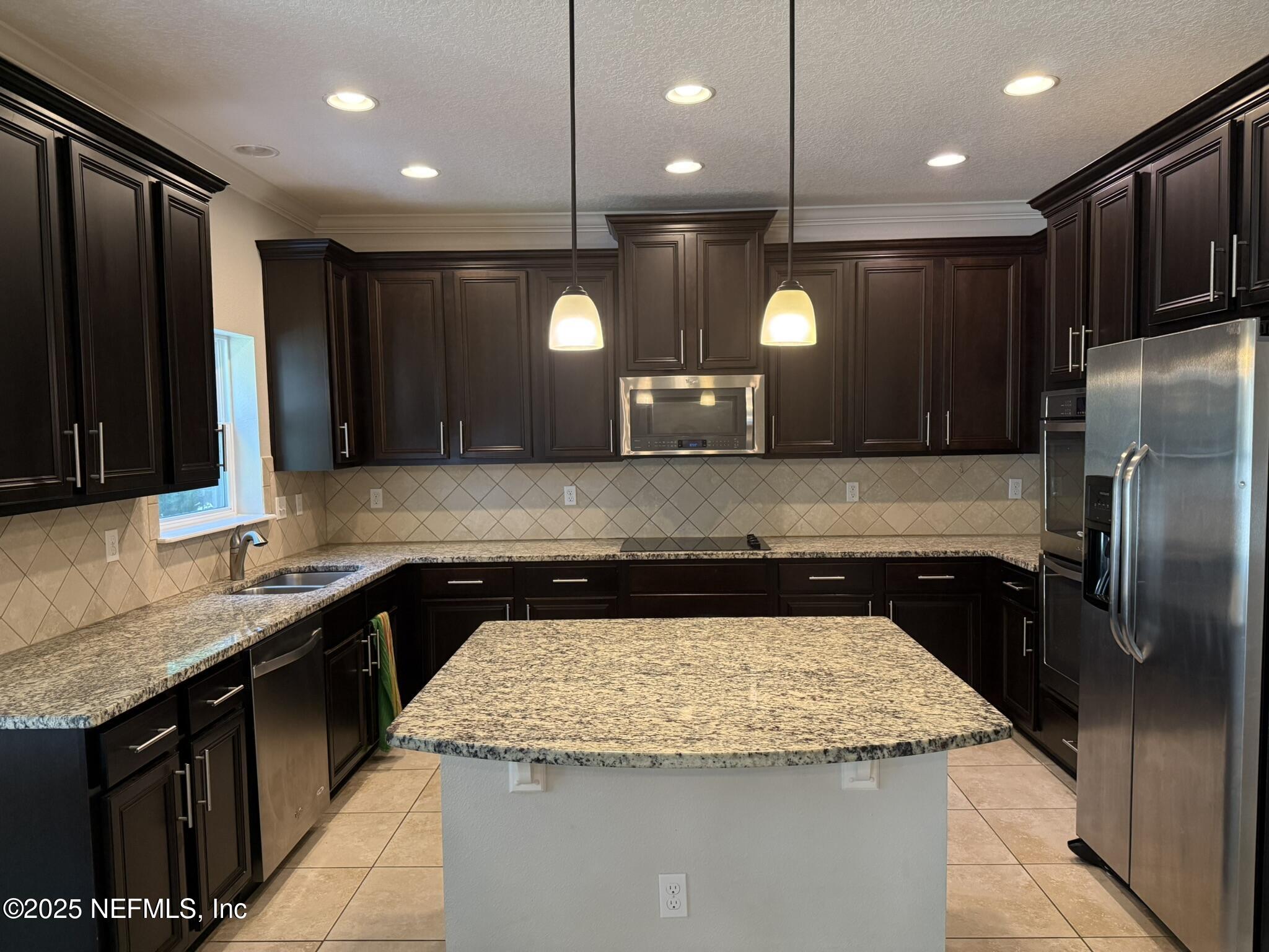 12198 Ridge Crossing Way Jacksonville, FL 32226 - Photo 11 of 28 a kitchen with a sink a counter space appliances and cabinets