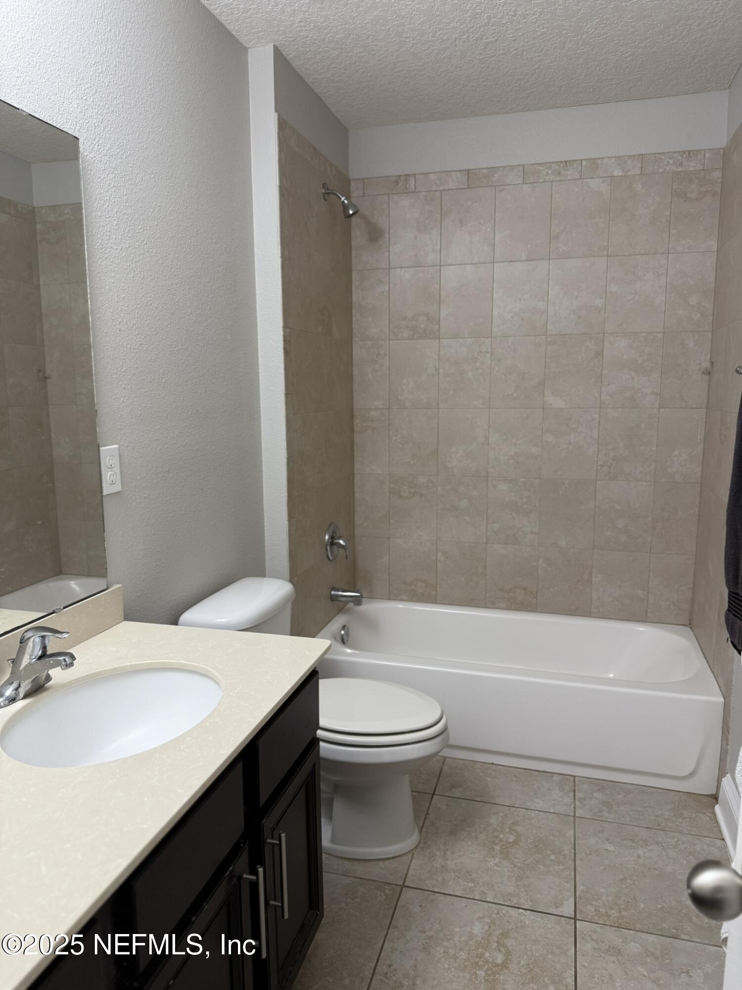 12198 Ridge Crossing Way Jacksonville, FL 32226 - Photo 17 of 28 a bathroom with a sink a toilet and a bathtub