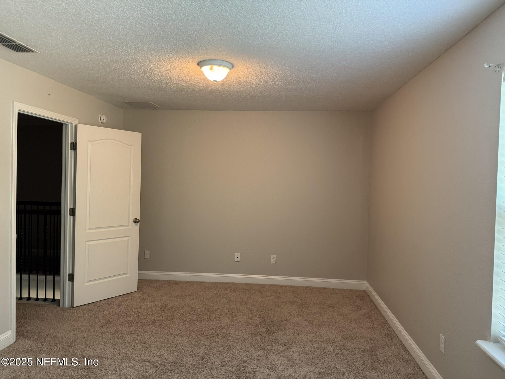 12198 Ridge Crossing Way Jacksonville, FL 32226 - Photo 18 of 28 an empty room with an entryway