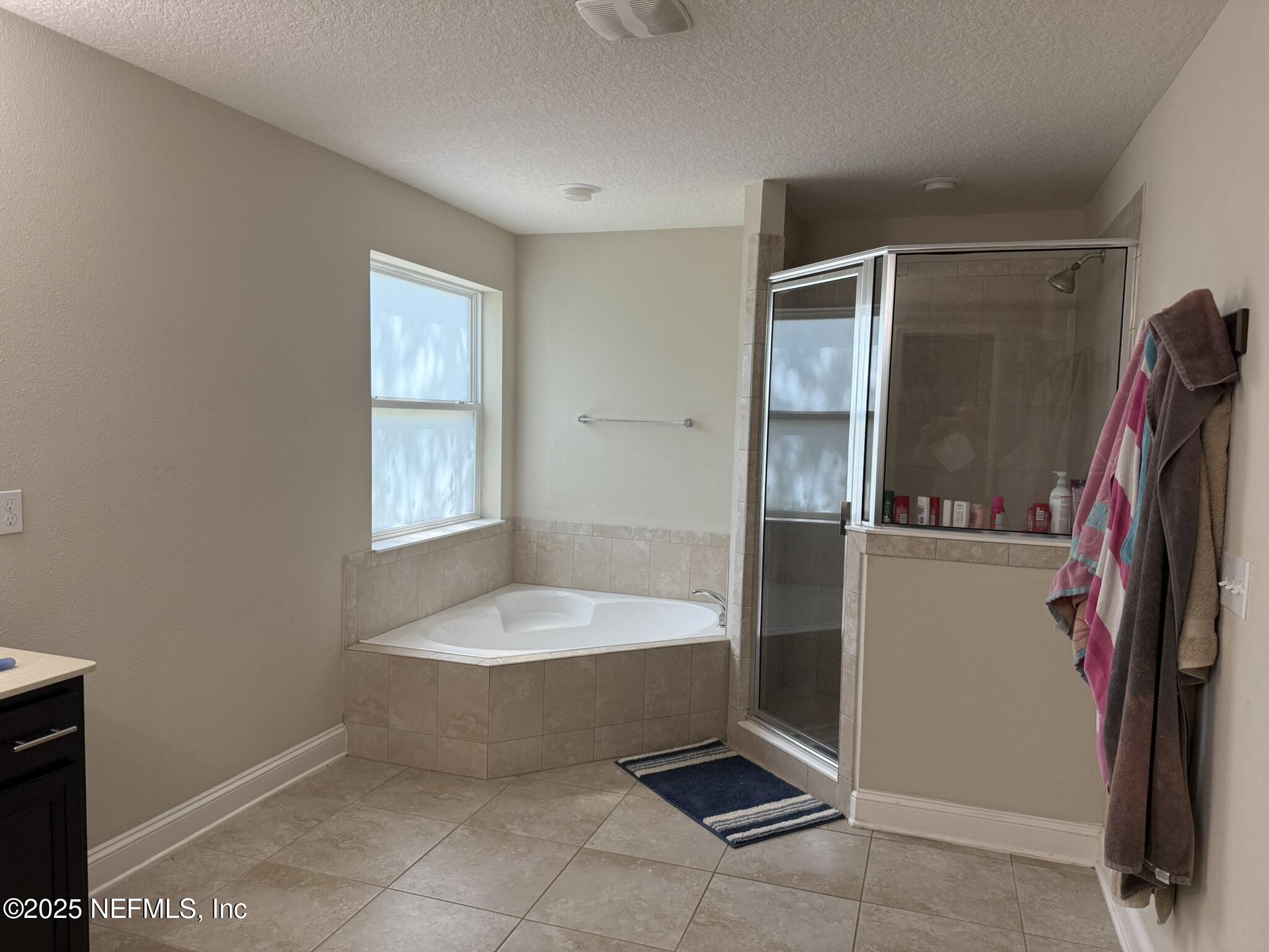12198 Ridge Crossing Way Jacksonville, FL 32226 - Photo 20 of 28 a bathroom with a tub and a shower