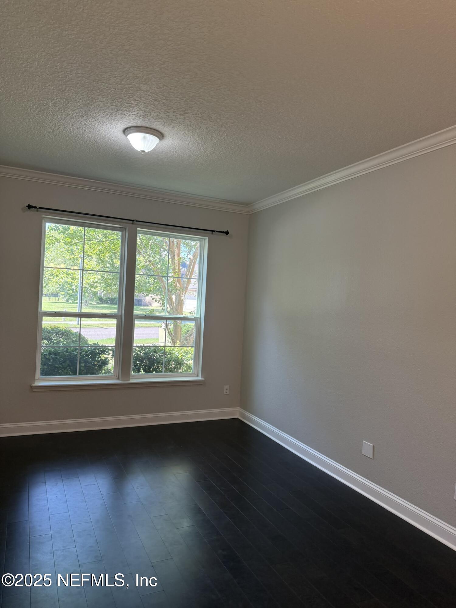 12198 Ridge Crossing Way Jacksonville, FL 32226 - Photo 2 of 28 an empty room with wooden floor and windows