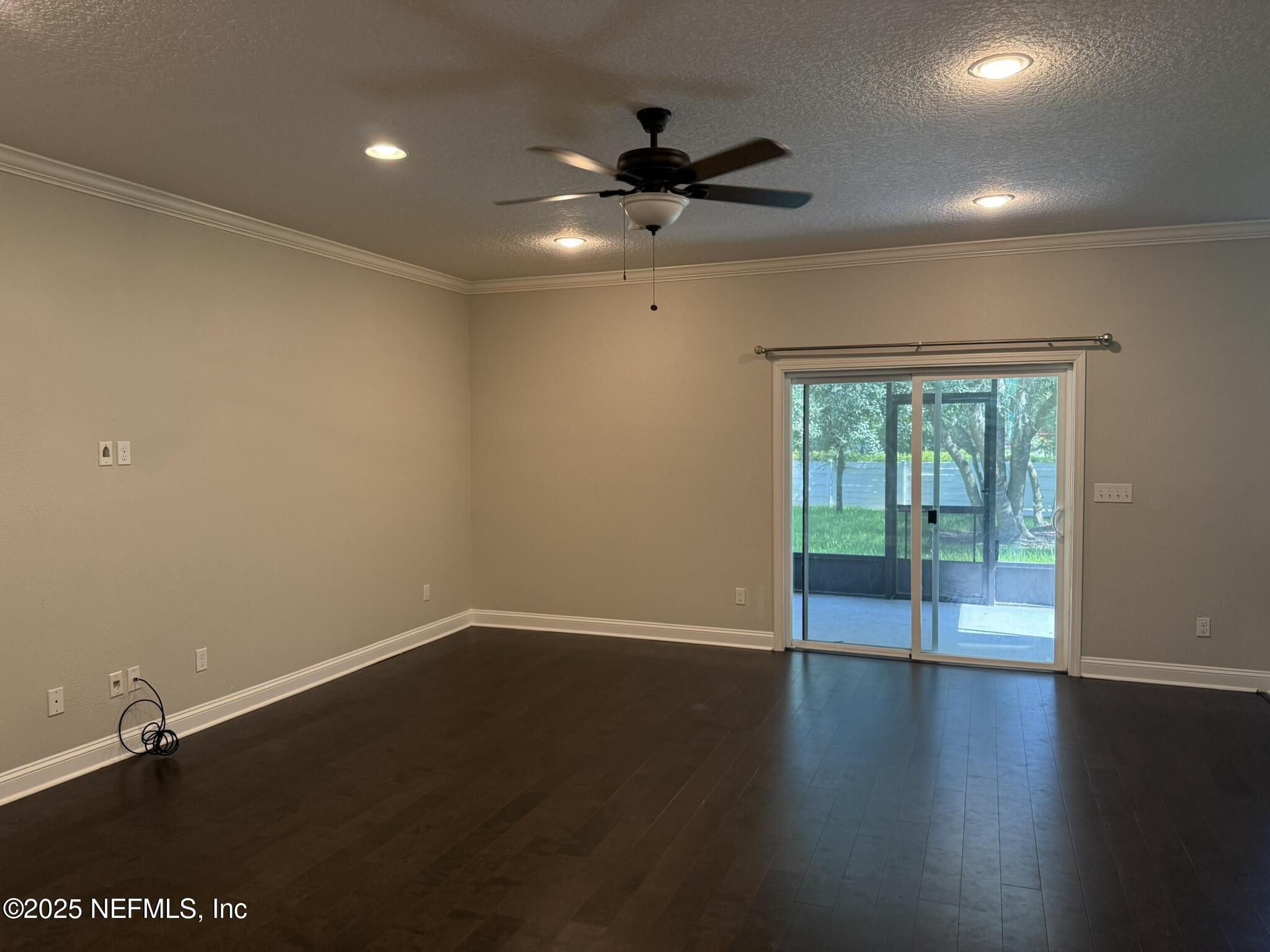 12198 Ridge Crossing Way Jacksonville, FL 32226 - Photo 5 of 28 a view of an empty room with wooden floor and a window