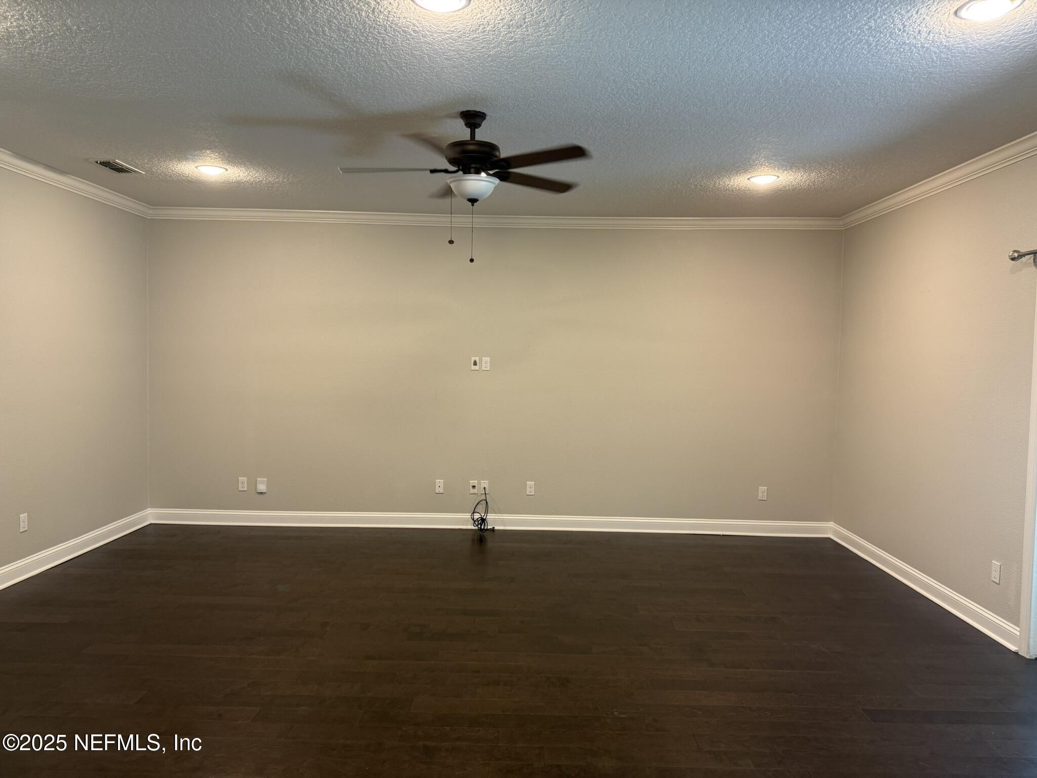 12198 Ridge Crossing Way Jacksonville, FL 32226 - Photo 6 of 28 an empty room with wooden floor and windows