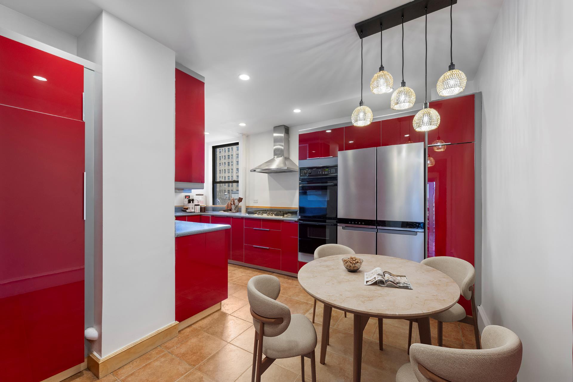 825 West End Avenue, Unit 7D Manhattan, NY 10025 - Photo 2 of 11 a kitchen with stainless steel appliances kitchen island granite countertop a dining table and chairs