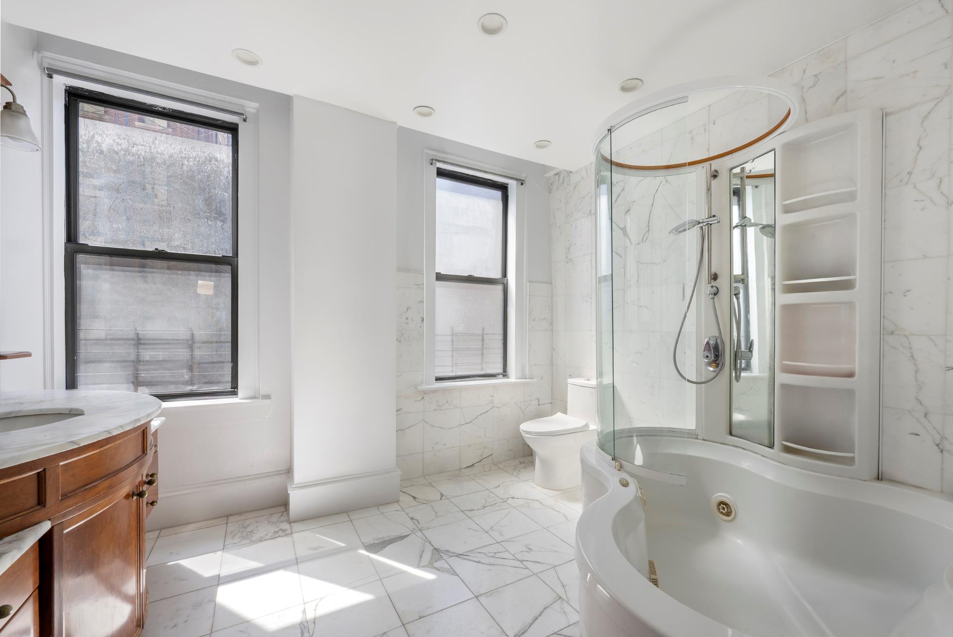 825 West End Avenue, Unit 7D Manhattan, NY 10025 - Photo 4 of 11 a bathroom with a tub shower and sink