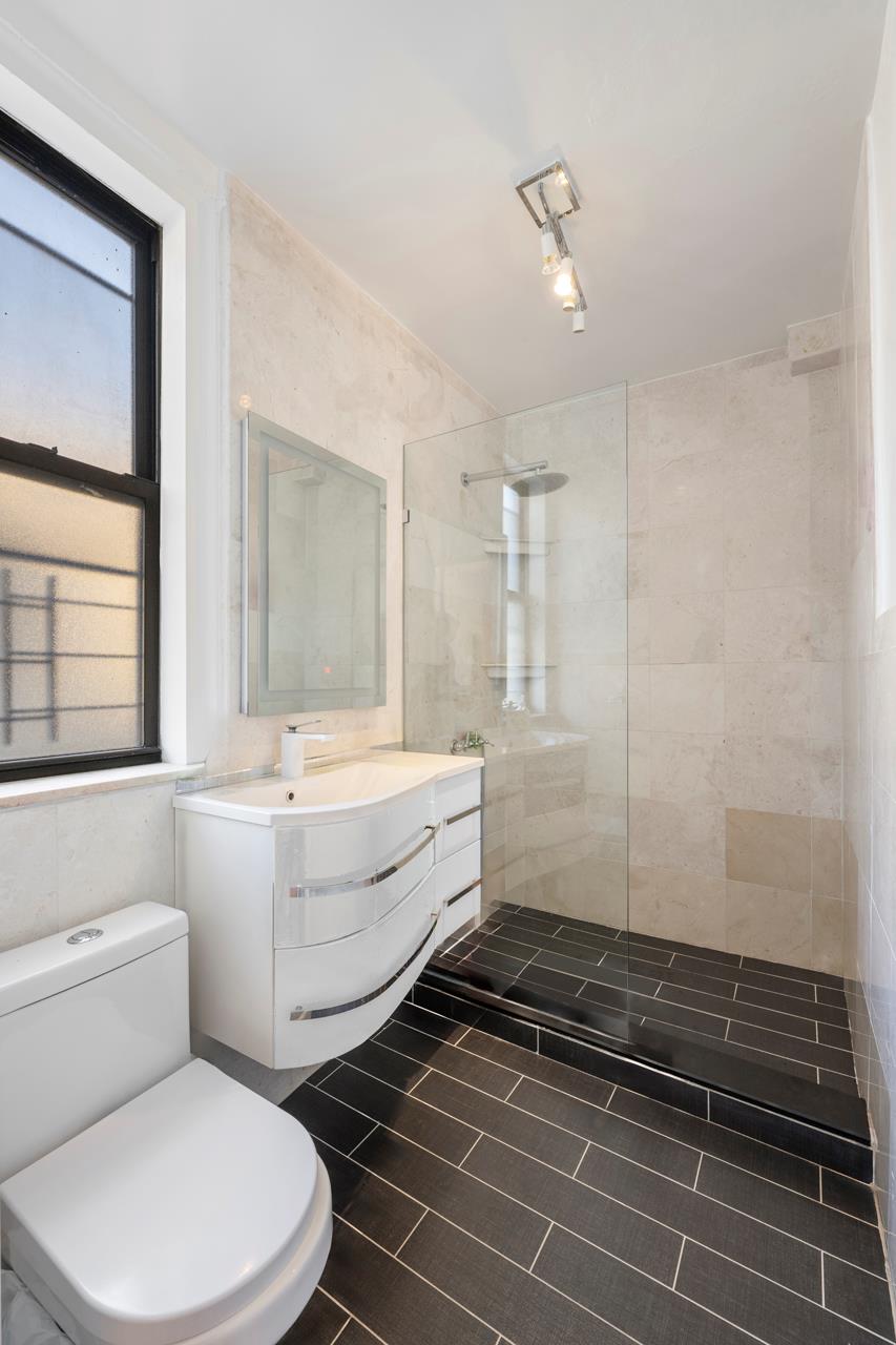 825 West End Avenue, Unit 7D Manhattan, NY 10025 - Photo 6 of 11 a bathroom with a sink a toilet and shower