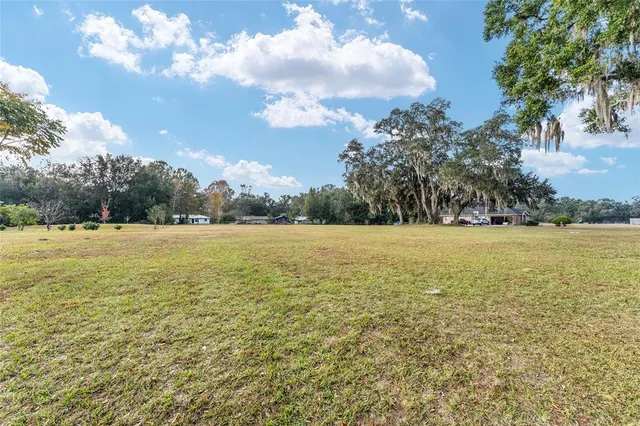 a aerial view of a house with yard and swimming pool