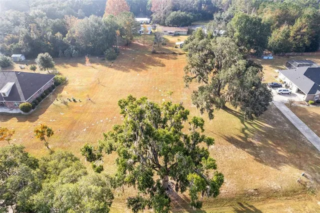 an aerial view of a houses with yard