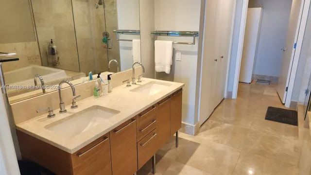 a bathroom with a sink double vanity and a mirror