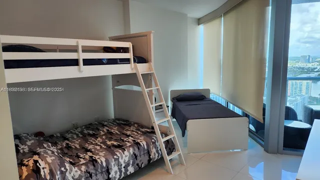 a bed sitting in a bedroom next to a window