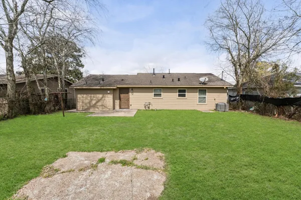 a view of a house with a yard and sitting area
