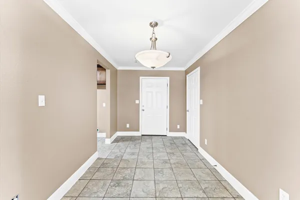 a view of a hallway with wooden floor and a window