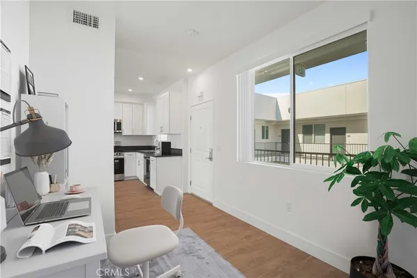 a kitchen with stainless steel appliances kitchen island a stove a sink a refrigerator and a microwave