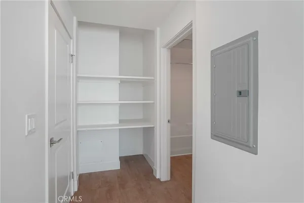 an empty room with a bathroom and mirror