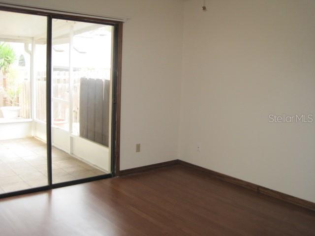 5415 Rutland Court Orlando, FL 32812 - Photo 11 of 25 a view of empty room with wooden floor and fan