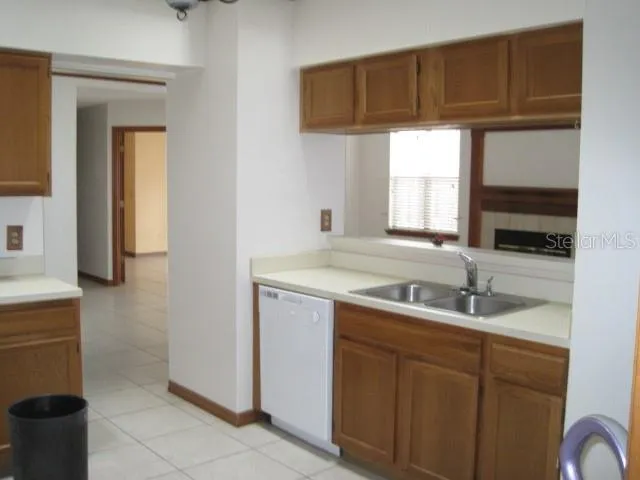 a kitchen with a sink cabinets and window